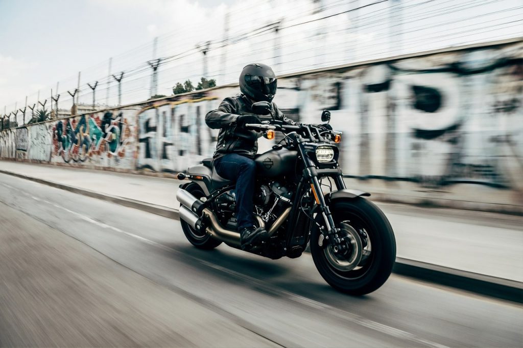 A person riding a motorcycle on a street, representing the need for legal support from a Rancho Cucamonga accident attorney.