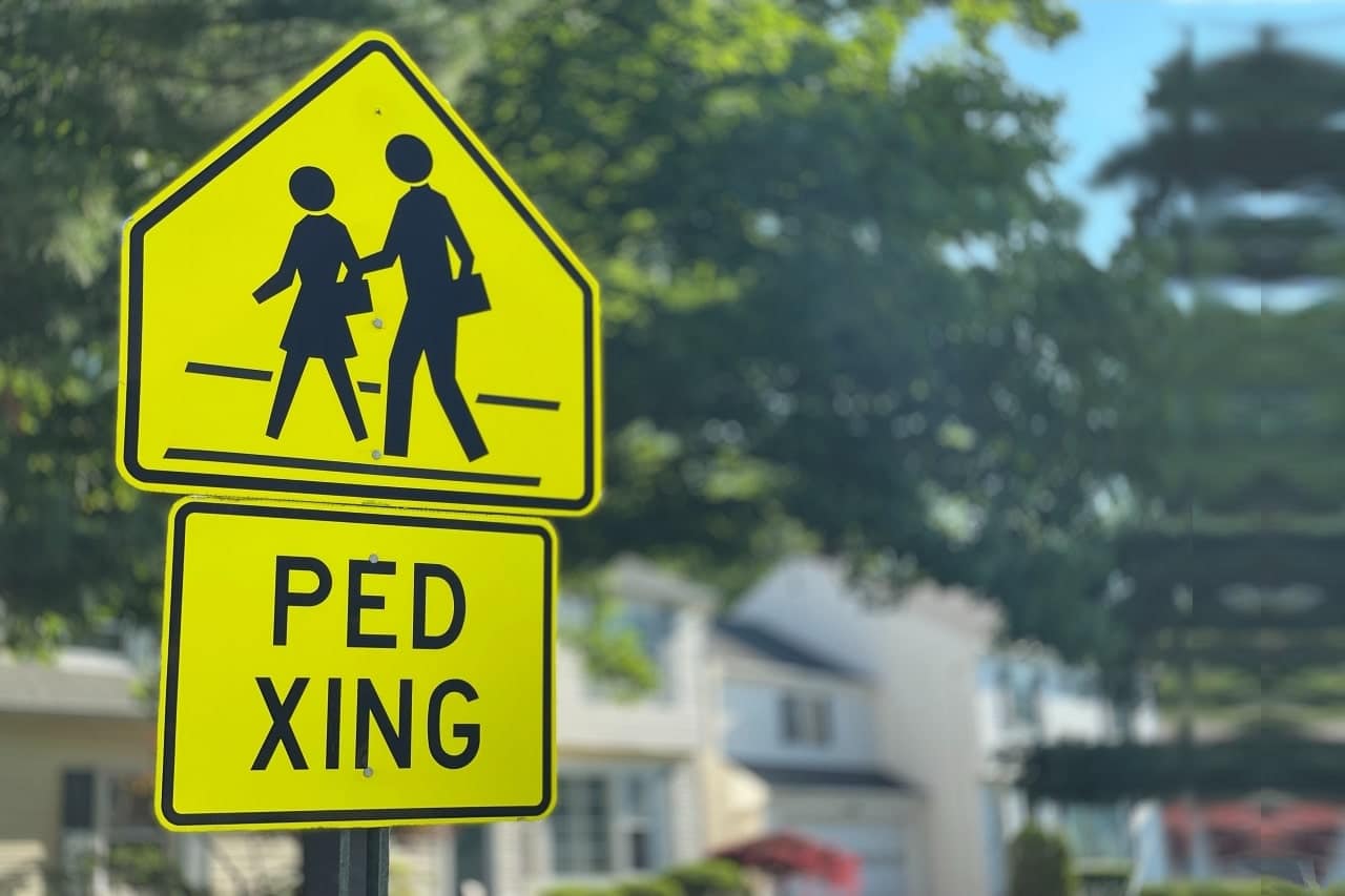 A yellow and black pedestrian crossing sign reading "Ped Xing," emphasizing safety for pedestrians in Rancho Cucamonga.