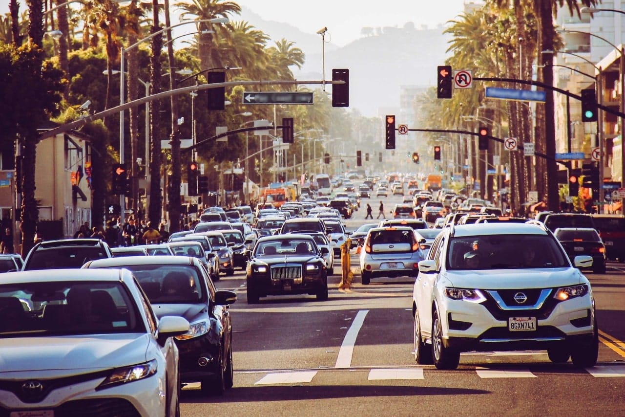 A bustling street filled with cars and traffic lights, highlighting the busy holiday season in Rancho Cucamonga.