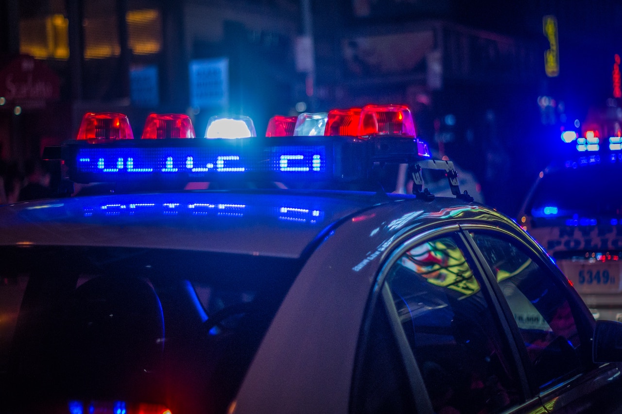 Police cars illuminate the street at night, highlighting the dangers of drunk driving in Rancho Cucamonga.