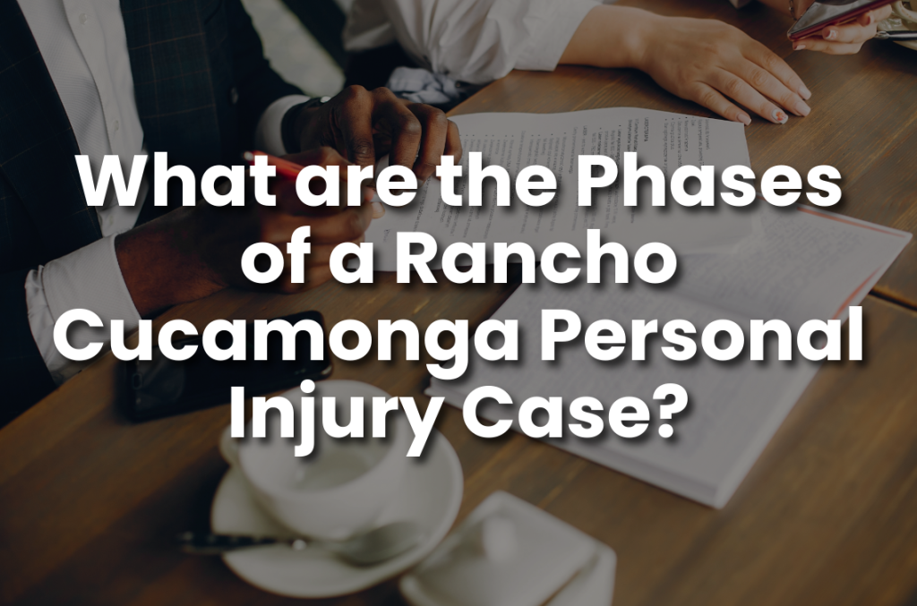 Attorney and client reviewing documents at a table, with text overlay about the phases of a Rancho Cucamonga personal injury case