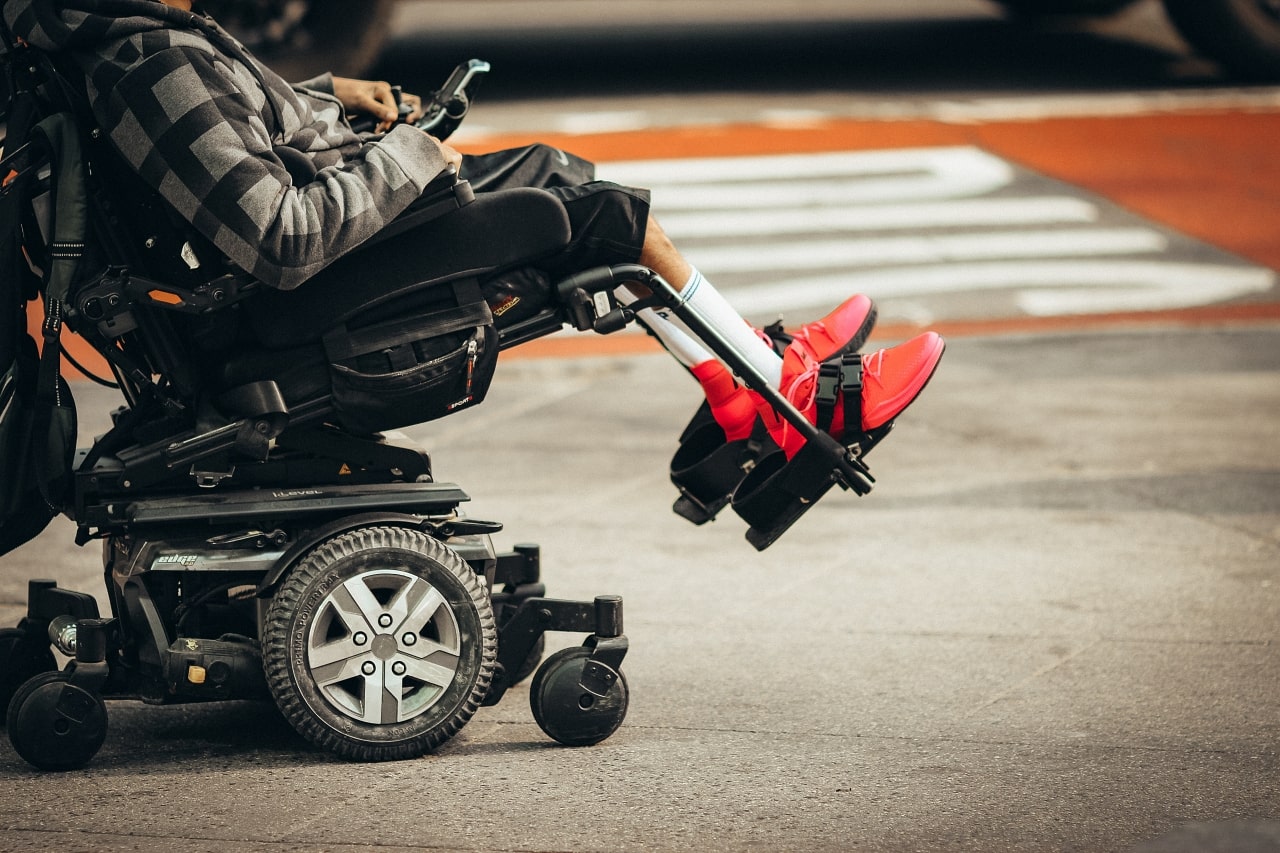 A person in a wheelchair wearing red shoes, symbolizing resilience and the pursuit of justice in personal injury cases.
