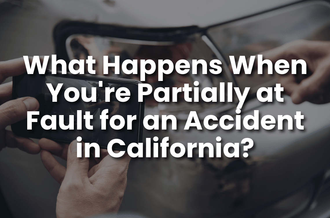 Hands taking a photo of a damaged car side mirror after a crash, representing a partially at-fault accident claim in California