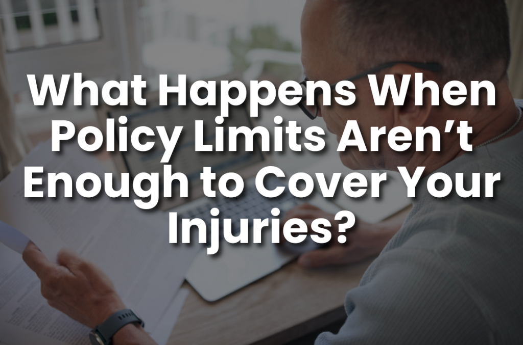 Man reviewing insurance documents at a laptop with the text “What Happens When Policy Limits Aren’t Enough to Cover Your Injuries?” for personal injury claim coverage and insurance policy limits.