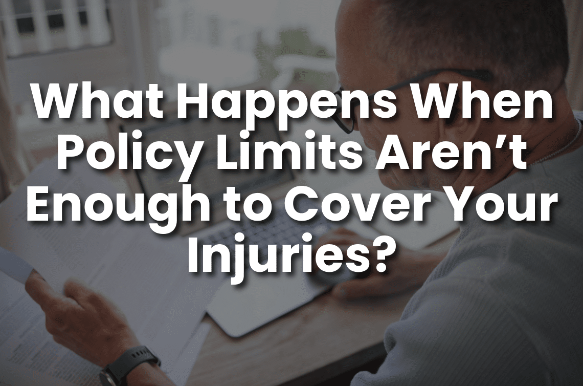Man reviewing insurance documents at a laptop with the text “What Happens When Policy Limits Aren’t Enough to Cover Your Injuries?” for personal injury claim coverage and insurance policy limits.